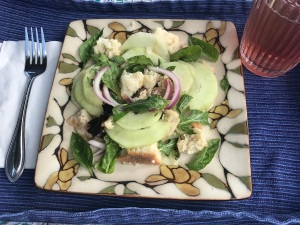 Plate of cucumbers, red onions, reconstituted bread and basil for Panzanella salad